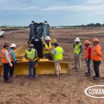 Ring Power instructor and COMANCO operators standing beside a new CAT D1 SSLGP low ground pressure dozer during on-site training